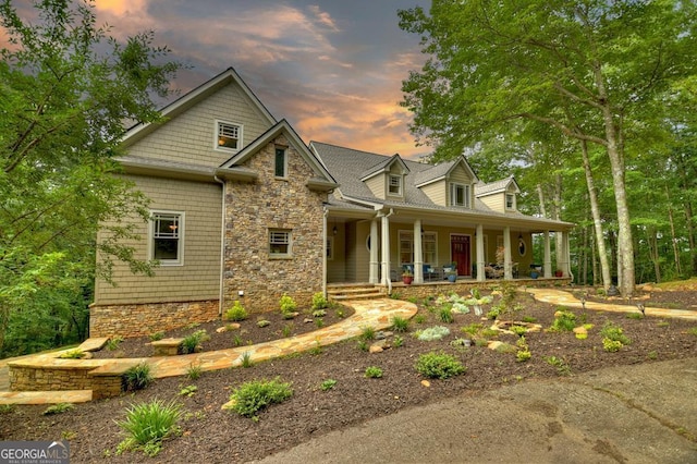 craftsman inspired home with a porch and stone siding