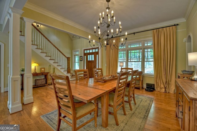 dining area with stairway, decorative columns, ornamental molding, and light wood finished floors