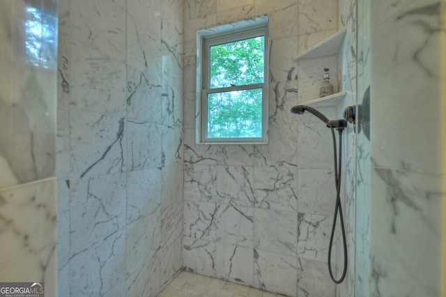 full bath with a marble finish shower