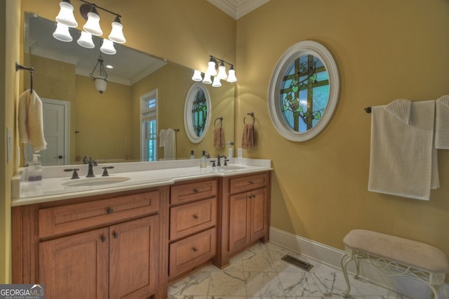bathroom with visible vents, a sink, marble finish floor, and ornamental molding