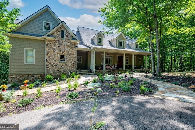 craftsman-style home with a porch and stone siding