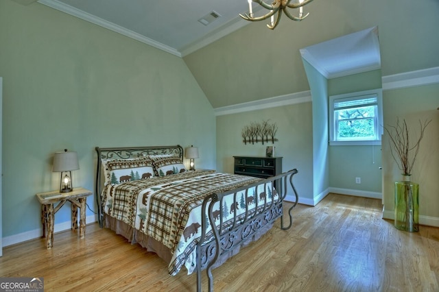 bedroom with baseboards, a chandelier, wood finished floors, and visible vents