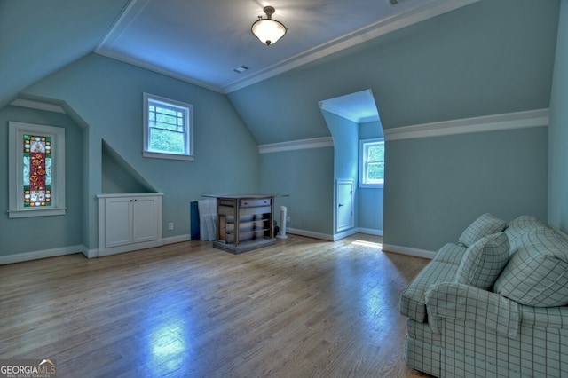 bonus room with baseboards, wood finished floors, and lofted ceiling