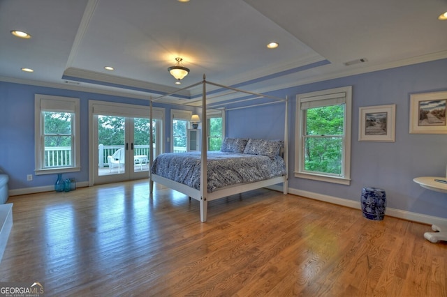 bedroom featuring french doors, access to outside, baseboards, ornamental molding, and a tray ceiling