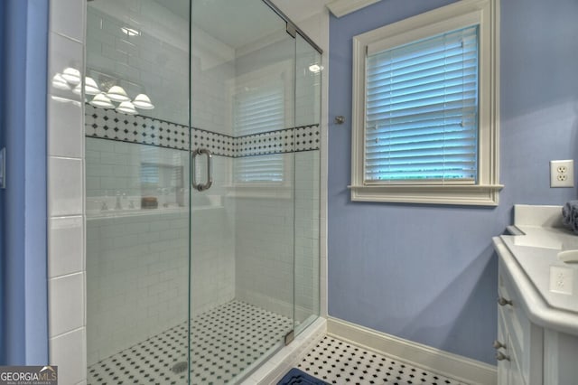 full bath featuring baseboards, a stall shower, and vanity