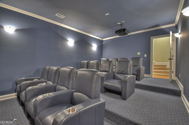 home theater room featuring carpet flooring, baseboards, and ornamental molding