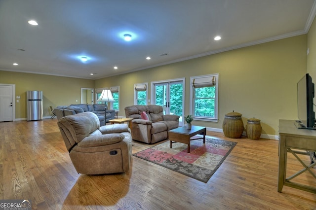 living area featuring baseboards, ornamental molding, wood finished floors, and recessed lighting