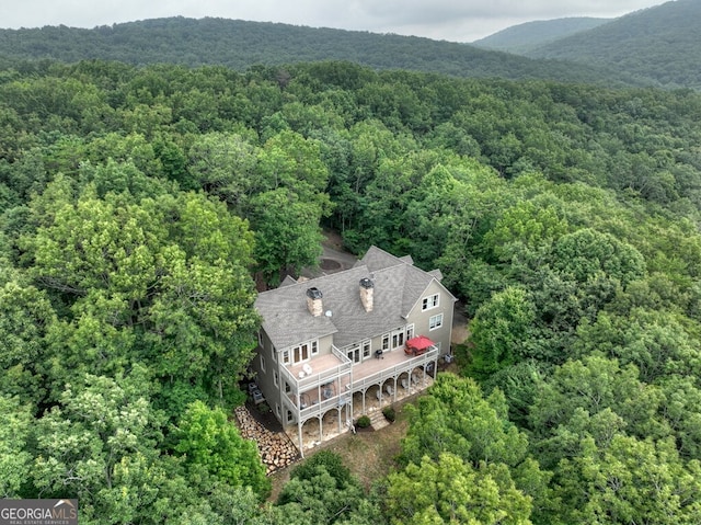 birds eye view of property with a view of trees
