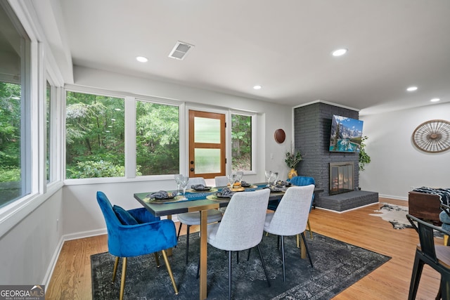 dining area with plenty of natural light, a fireplace, baseboards, and recessed lighting