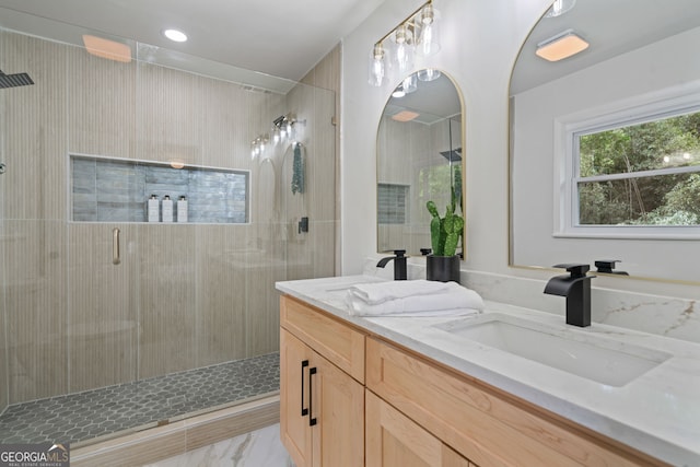 full bath with a shower stall, double vanity, and marble finish flooring