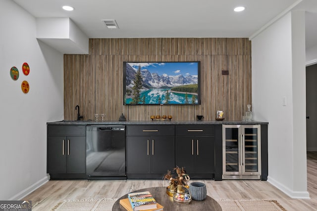 indoor wet bar featuring wine cooler, dishwasher, an accent wall, light wood-type flooring, and recessed lighting