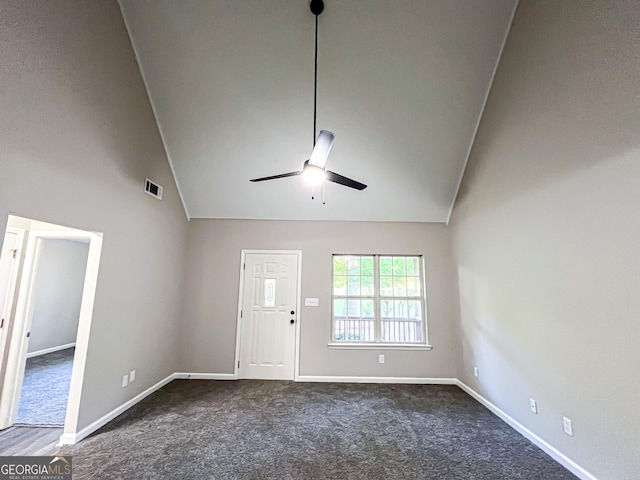 interior space with a ceiling fan, visible vents, baseboards, high vaulted ceiling, and dark colored carpet