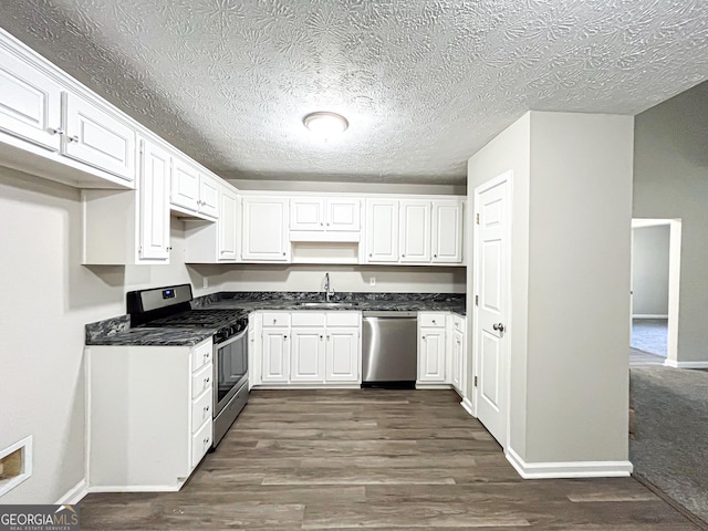 kitchen with dark wood-type flooring, a sink, baseboards, and stainless steel appliances