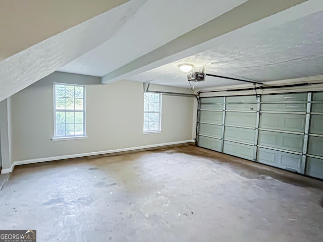 garage featuring baseboards and a garage door opener