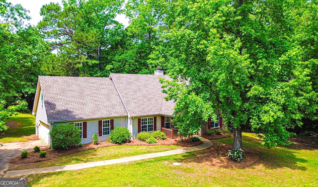 cape cod home featuring a garage, a chimney, driveway, and a front yard