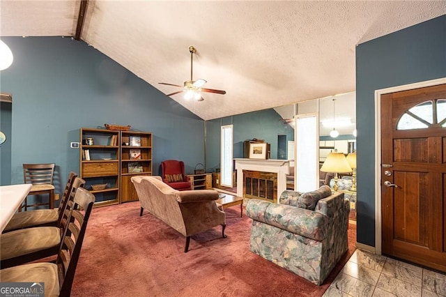 633 Iris Rd, Pine Lake, GA 30072 - living room featuring a ceiling fan, vaulted ceiling, a glass covered fireplace, and a textured ceiling