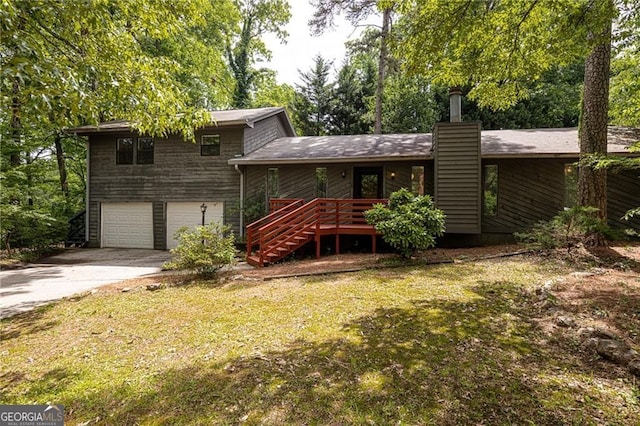 633 Iris Rd, Pine Lake, GA 30072 - rear view of property featuring an attached garage, driveway, stairs, a lawn, and a chimney