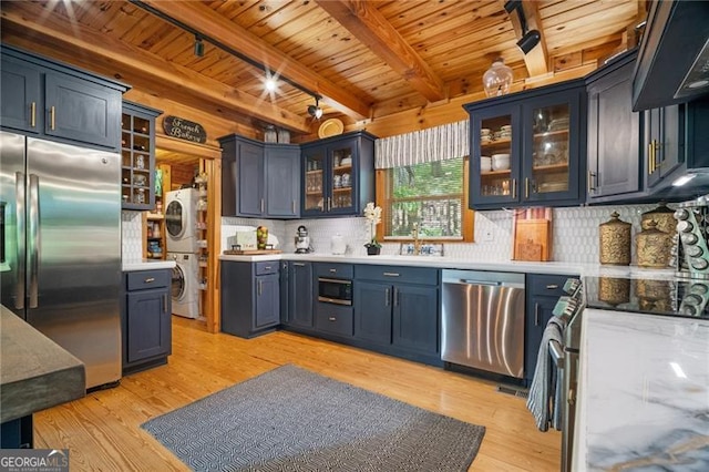 334 Little Pine Mountain Rd, Jasper, GA 30143 - kitchen with appliances with stainless steel finishes, wooden ceiling, light wood-style flooring, and stacked washer and clothes dryer