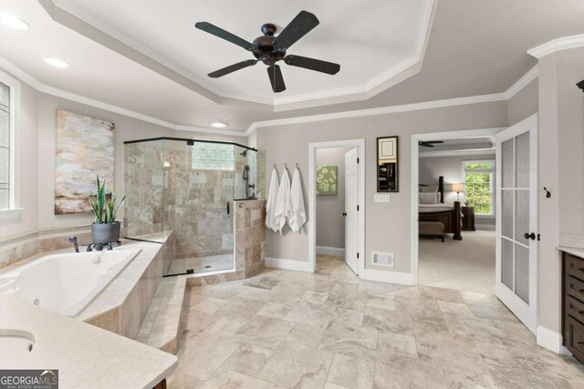 ensuite bathroom with a bath, visible vents, a shower stall, vanity, and a tray ceiling