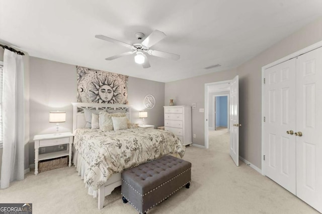 bedroom with a ceiling fan, baseboards, light colored carpet, and a closet