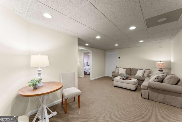 living room with carpet floors, baseboards, a drop ceiling, and recessed lighting