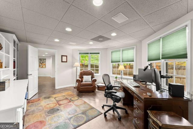 office area featuring recessed lighting, baseboards, and a drop ceiling