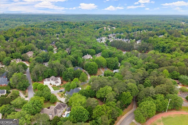 aerial view featuring a wooded view