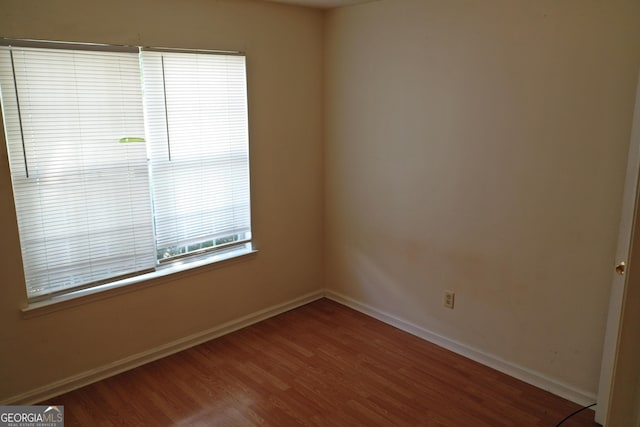 302 Kensington Cir, Warner Robins, GA 31093 - spare room featuring baseboards and wood finished floors