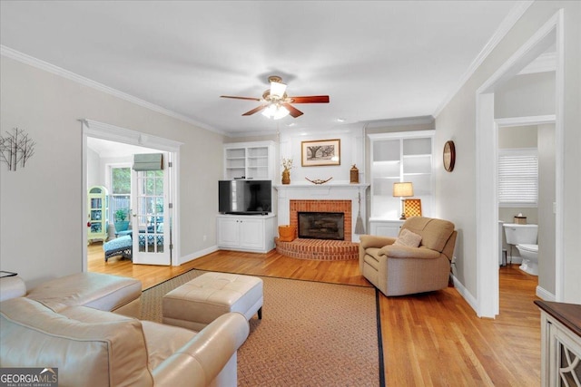 6034 Addington Dr NW, Acworth, GA 30101 - living area with ceiling fan, a fireplace, baseboards, light wood-type flooring, and ornamental molding