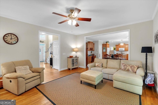 6034 Addington Dr NW, Acworth, GA 30101 - living area with crown molding, ceiling fan, and light wood-style flooring