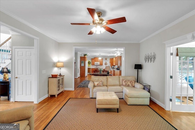 6034 Addington Dr NW, Acworth, GA 30101 - living area featuring crown molding, ceiling fan, baseboards, and light wood-type flooring