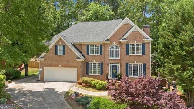 6034 Addington Dr NW, Acworth, GA 30101 - colonial-style house with a garage, concrete driveway, brick siding, and a chimney