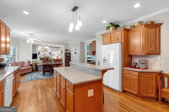 6034 Addington Dr NW, Acworth, GA 30101 - kitchen with ceiling fan, a kitchen island, ornamental molding, white appliances, and light wood-style flooring
