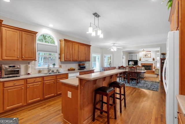 6034 Addington Dr NW, Acworth, GA 30101 - kitchen featuring a sink, light countertops, light wood finished floors, open floor plan, and white appliances
