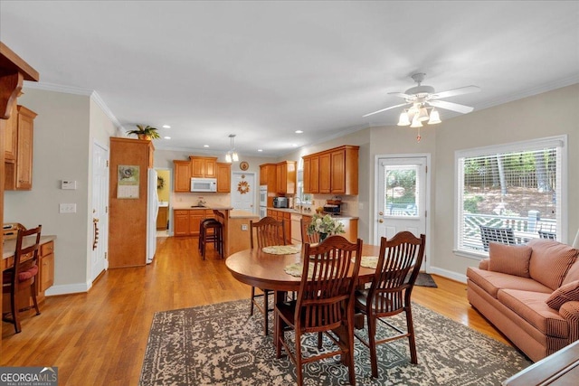 6034 Addington Dr NW, Acworth, GA 30101 - dining space featuring baseboards, ceiling fan, ornamental molding, and light wood-style flooring