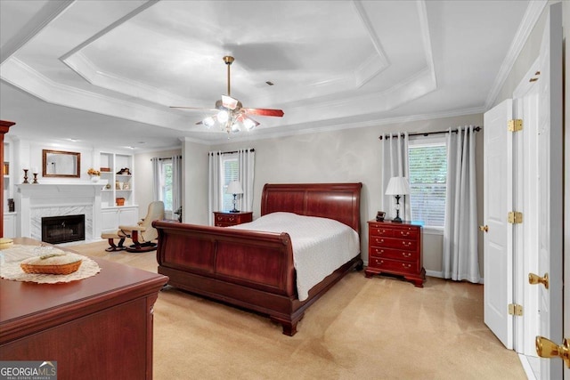 6034 Addington Dr NW, Acworth, GA 30101 - bedroom with ornamental molding, a fireplace, light carpet, ceiling fan, and a tray ceiling