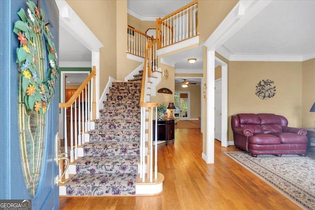 6034 Addington Dr NW, Acworth, GA 30101 - entrance foyer featuring ornamental molding, wood finished floors, and stairway