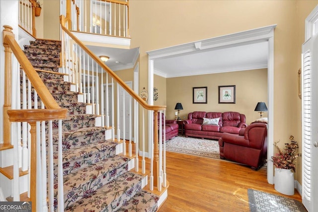 6034 Addington Dr NW, Acworth, GA 30101 - staircase with crown molding and wood finished floors