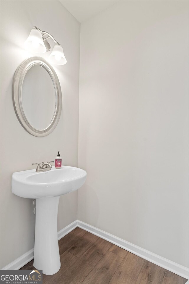 bathroom featuring baseboards and wood finished floors
