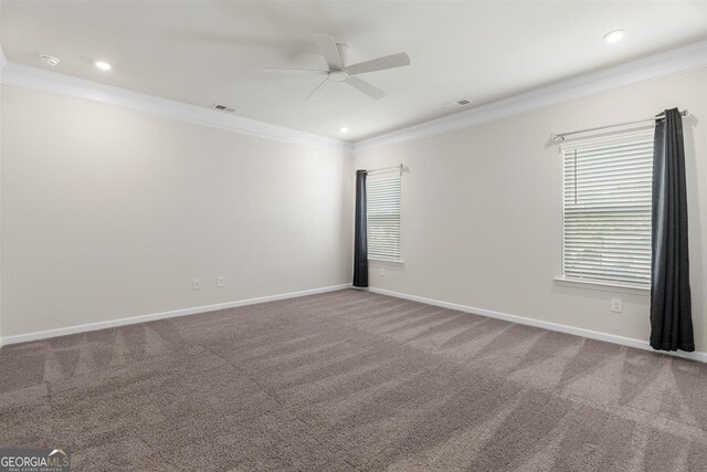 spare room featuring crown molding, carpet, a ceiling fan, and visible vents