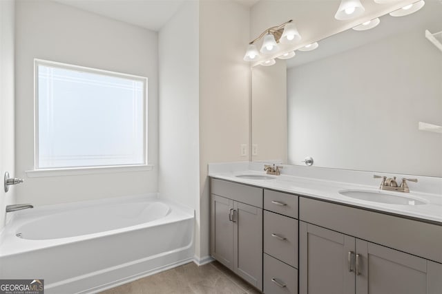 bathroom featuring a sink, baseboards, double vanity, and a bath