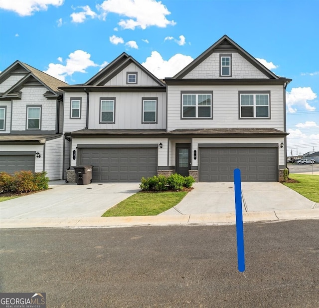 multi unit property with an attached garage and concrete driveway