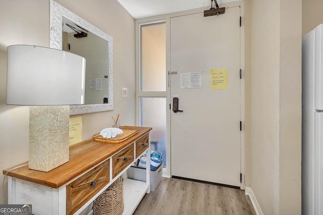 doorway to outside featuring light wood finished floors