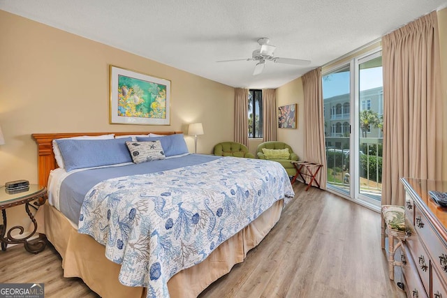 bedroom with light wood-style floors, a ceiling fan, a textured ceiling, and access to exterior