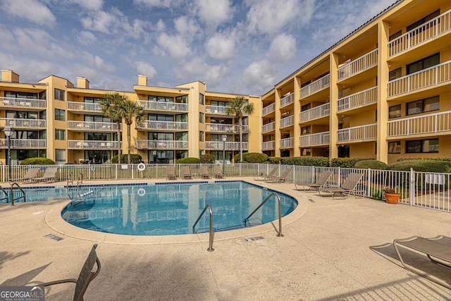 pool featuring a patio area and fence