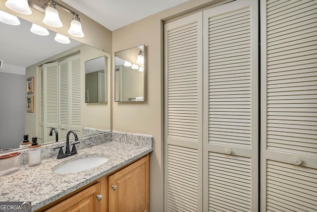 bathroom with vanity and a closet