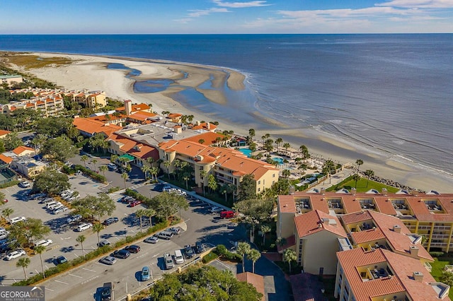 drone / aerial view featuring a water view and a view of the beach