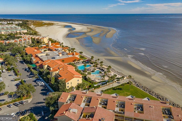 bird's eye view with a water view and a beach view