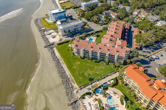 drone / aerial view with a water view and a beach view