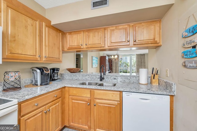 201 Neptune Rd Unit 258, Saint Simons, GA 31522 - kitchen featuring visible vents, dishwasher, a sink, light stone counters, and a chandelier
